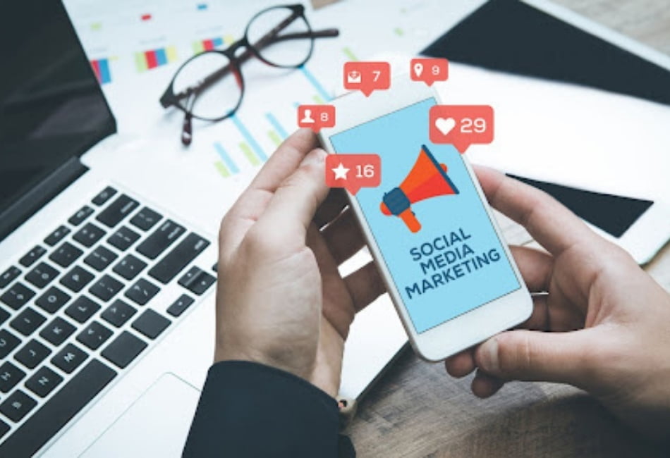 Social Media Management by phone on his desk pc and glasses