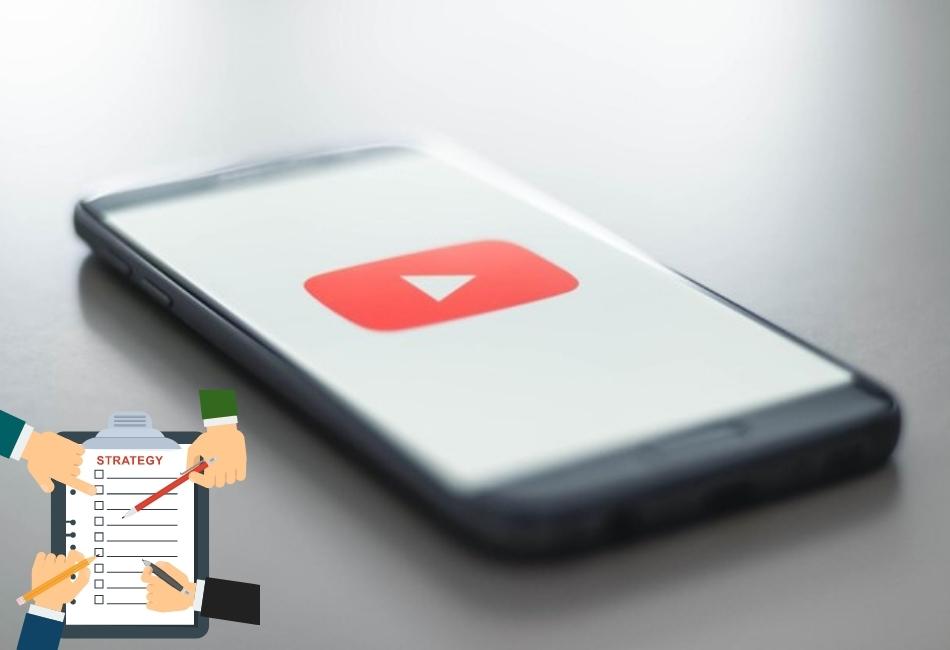an Iphone with youtube logo and a Blok note strategy