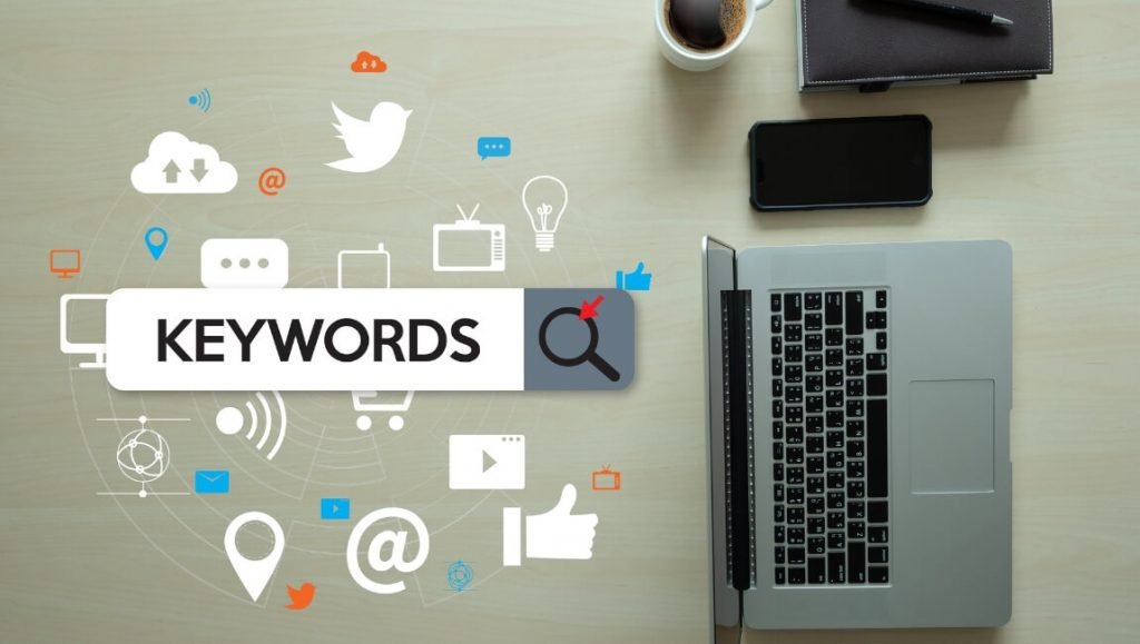Optimize Keywords is an image on the desk with a computer and social media
